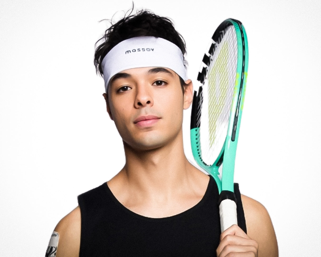 A young man with short dark hair and a neutral expression poses against a plain white background, wearing a Massov Sports Headband and a black sleeveless shirt while holding a teal and white tennis racket over his shoulder.