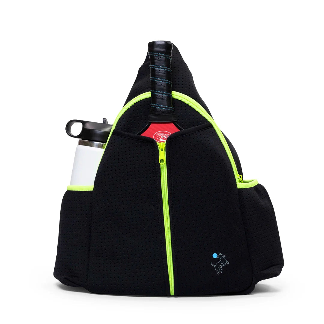 The Swinton Pickleball Sling Bag - Black (Personalization Available) features neon yellow zippers, a small embroidered dog logo, a tennis racket front pocket, and side pocket with a white water bottle. It stands upright on a white background.