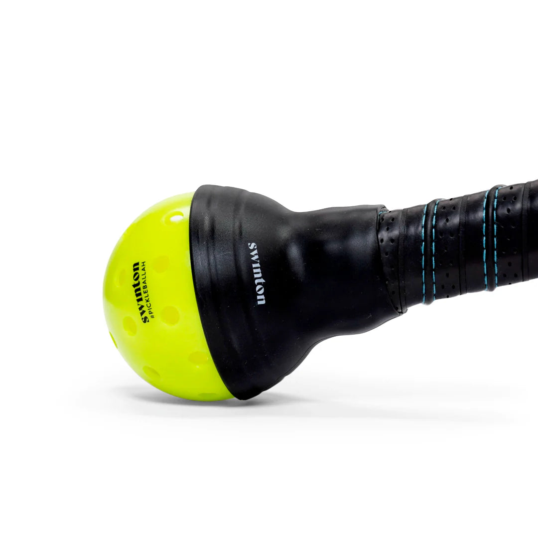 A close-up of a yellow Swinton Pickleball Suck Up ball, essential for use with a paddle or the Suck Up picker accessory.
