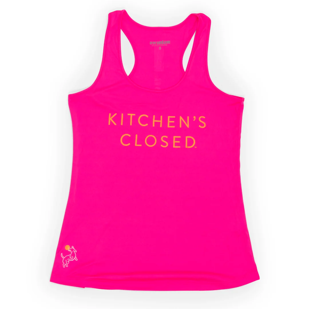The Swinton Pickleball Women's Pickleball Performance Tank in hot pink features gold “KITCHEN’S CLOSED” text, a moisture-wicking racerback design, and a white and gold chef graphic on the lower left hem. Displayed on a plain white background.