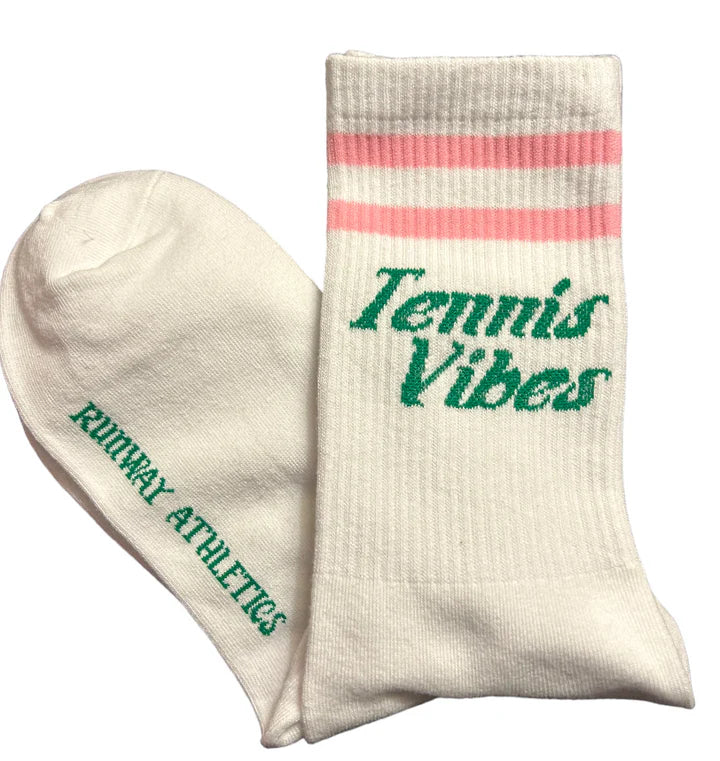 The Tennis Vibes - Gift Set by Runway Athletics includes white crew socks with two pink stripes, “Tennis Vibes” in green cursive on one sock, and “RUNWAY ATHLETICS” in bold green on the other—ideal for tennis lovers!.