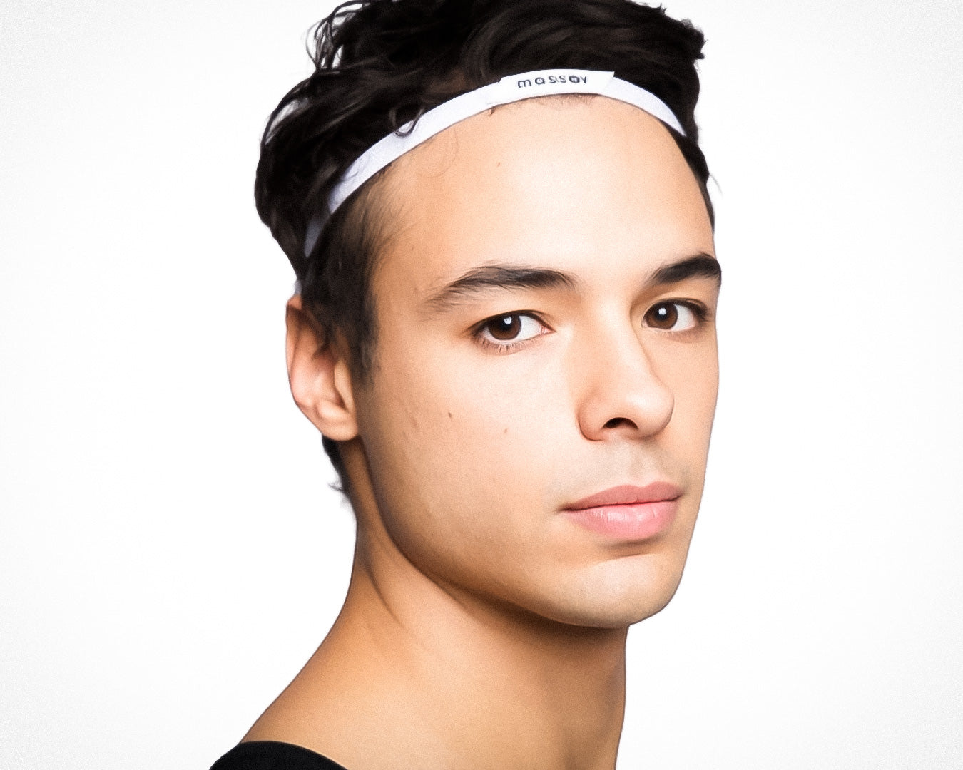 A young man with short, dark hair wears a Massov Thin Sports Headband. He has smooth skin, brown eyes, and a neutral expression, facing slightly to the side against a white background.