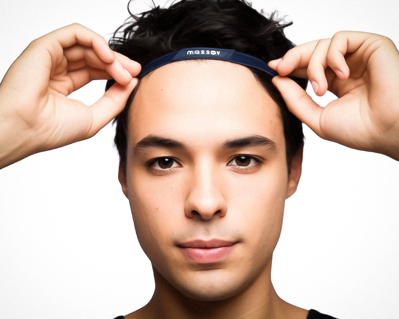 A young person with short dark hair uses both hands to adjust a black Massov Thin Sports Headband on their forehead. They face forward with a neutral expression against a plain white background.
