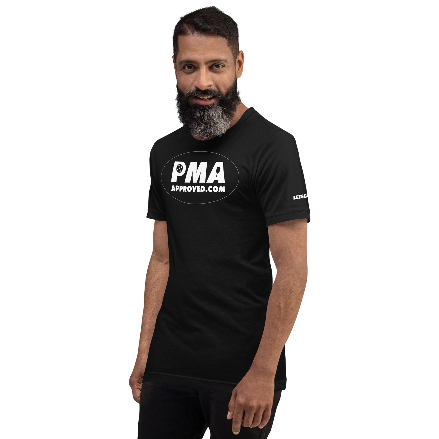 A person with a dark beard and short hair smiles while wearing a Crown Pickleball PICKLEBALL MANUFACTURERS ASSOCIATION - Logo Shirt (Black) featuring white logo text, standing against a plain white background.