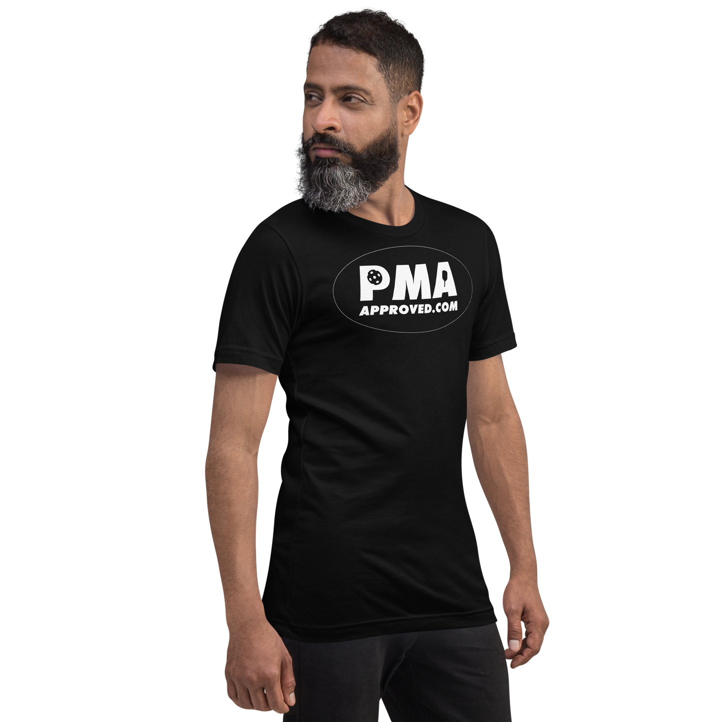 A man with a dark beard and short hair faces left, wearing the Crown Pickleball PICKLEBALL MANUFACTURERS ASSOCIATION - Logo Shirt (Black), featuring “PMA APPROVED.COM” in white on the chest, against a plain white background.
