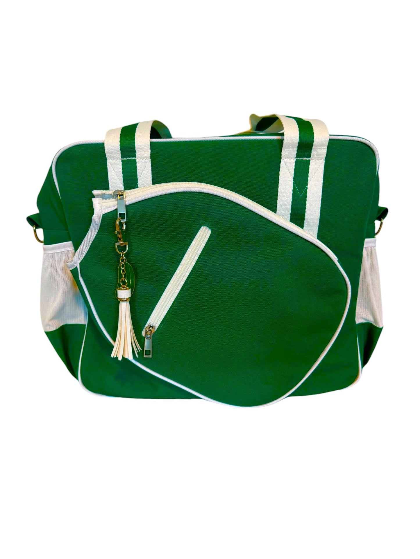 The Lola Pickleball Tote Bag by Fresh Pickle features a green design with white trim, white diagonal front zipper pocket, white handles, two side mesh pockets, and a white tassel keychain. Shown on a plain white background.