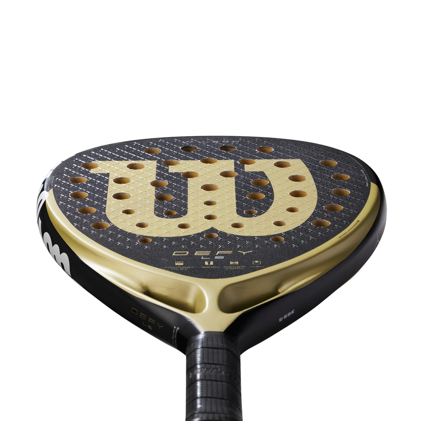 Close-up of the Wilson Defy LS V1 Padel Racket by Padel USA, featuring a black and gold aerodynamic power design with a bold gold W logo, perforated surface, and striking grip tape, set against a plain white background.