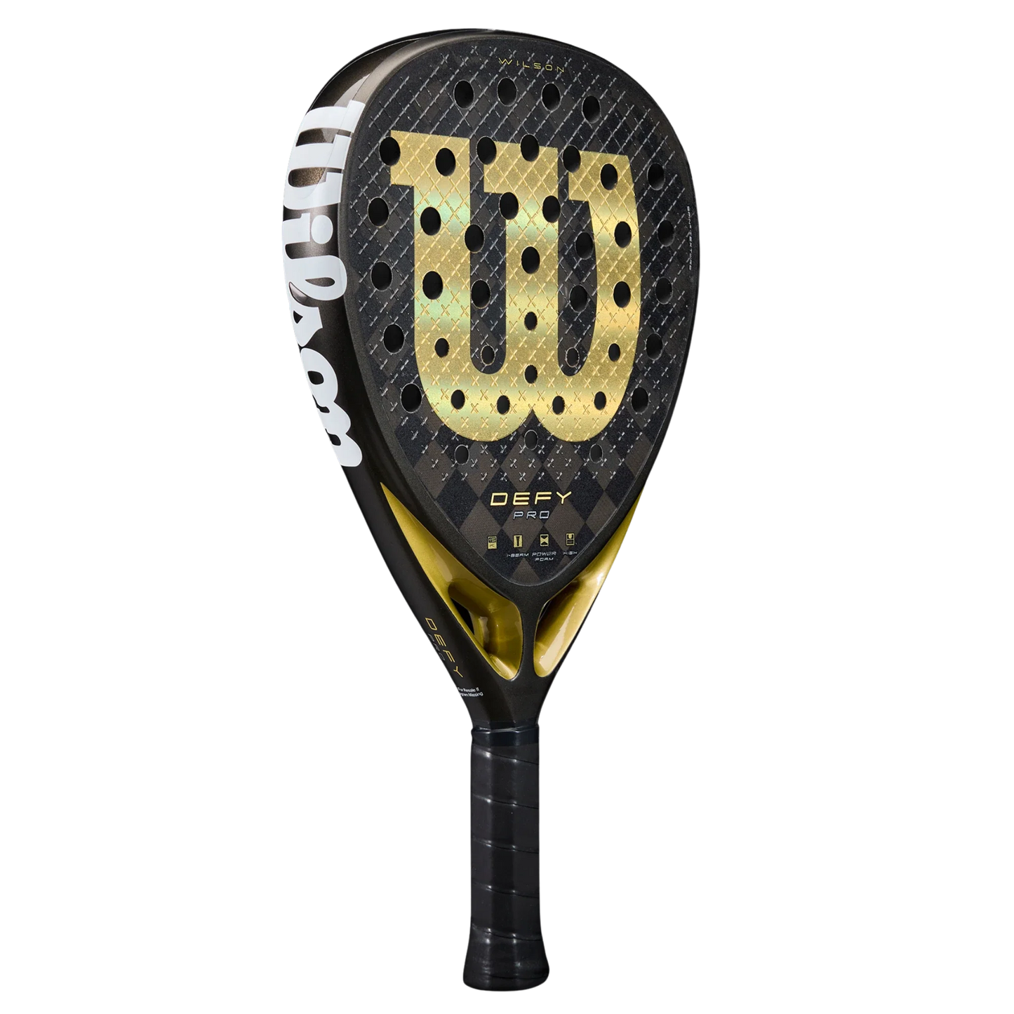 The Wilson Defy Pro V1 Padel Racket by Padel USA features a black and gold design, bold “W” logo, round holes, ribbed grip, 15K Carbon Face, "DEFY PRO" near the neck, and "Wilson" in white along the side on a plain background.