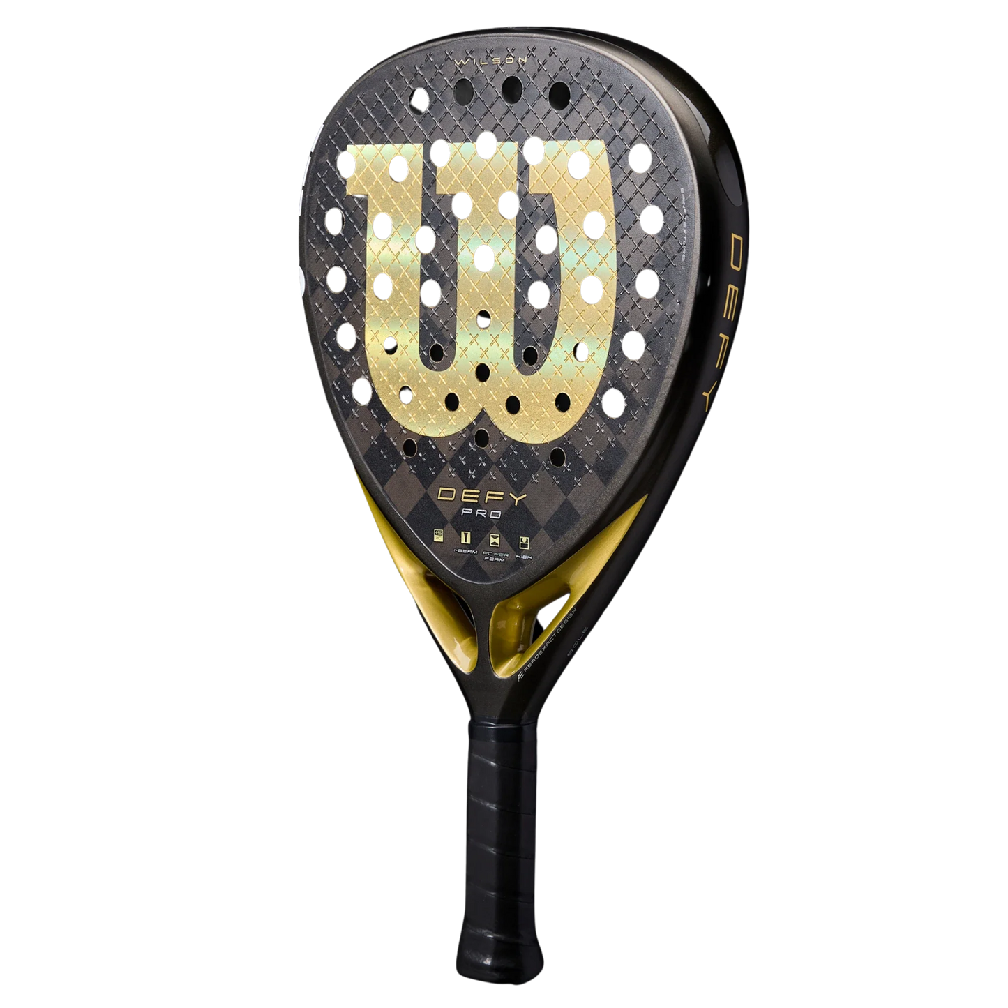 The Wilson Defy Pro V1 padel racket from Padel USA features a black and gold design, 15K Carbon Face, teardrop shape, perforated surface, large gold W logo, printed brand/model names near the handle, and a black grip wrap.