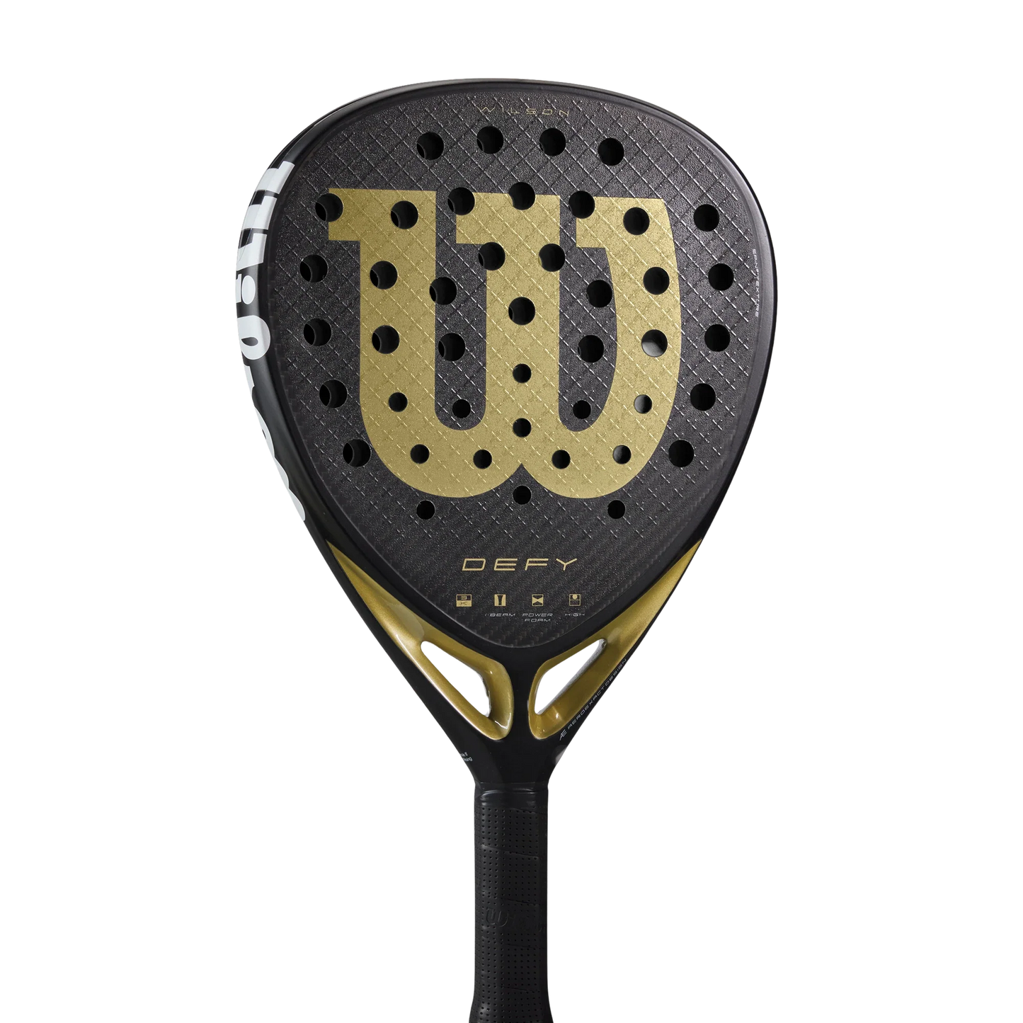 The Wilson Defy V1 Padel Racket from Padel USA has a black 3K Carbon Face, gold W logo, circular holes, "DEFY" text below, and a black handle with a partial white WILSON logo on the edge. Background is plain white.