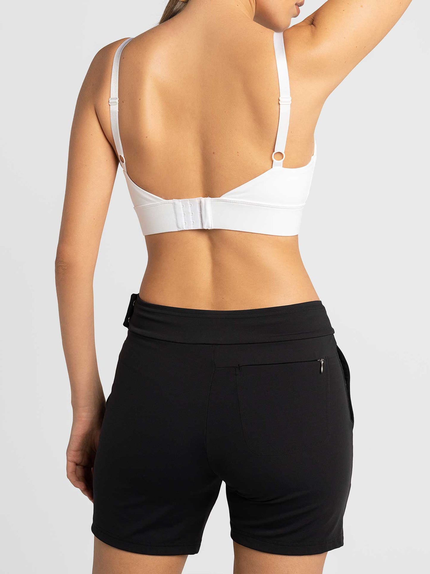 A woman wearing the inPhorm NYC Women's Cleo Short in black—stylish, functional, and crafted for active lifestyles with moisture management for all-day comfort.