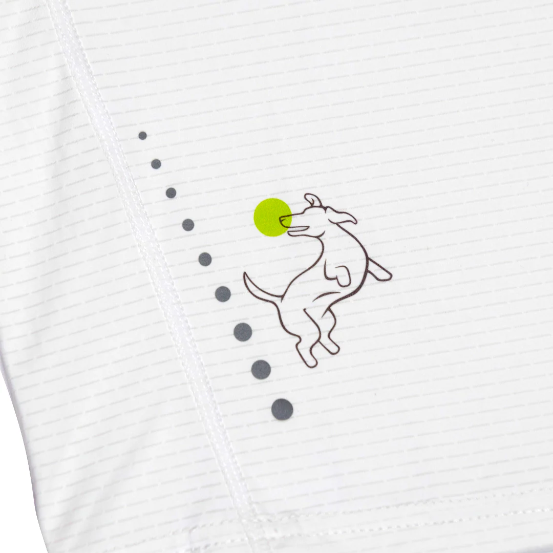 The Swinton Pickleball Women's Pickled 'em LUX Performance Shirt features a playful line drawing of a dog chasing a yellow-green ball, with dotted path details, on soft, striped fabric—perfect for fun pickleball style and top performance.