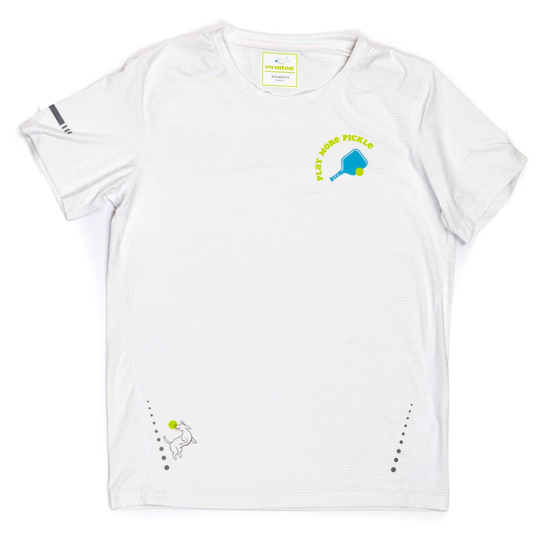 The Swinton Pickleball Women's Pickled 'em LUX Performance Shirt is a white, short-sleeve top with a blue and yellow paddle and "PLAY MORE PICKLE" on the chest, a dog with a green pickleball at the hem, and gray sleeve stripes.